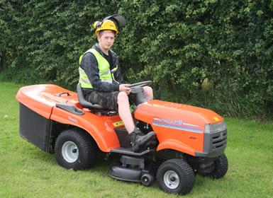 One of our gardeners sitting on a garden tractor